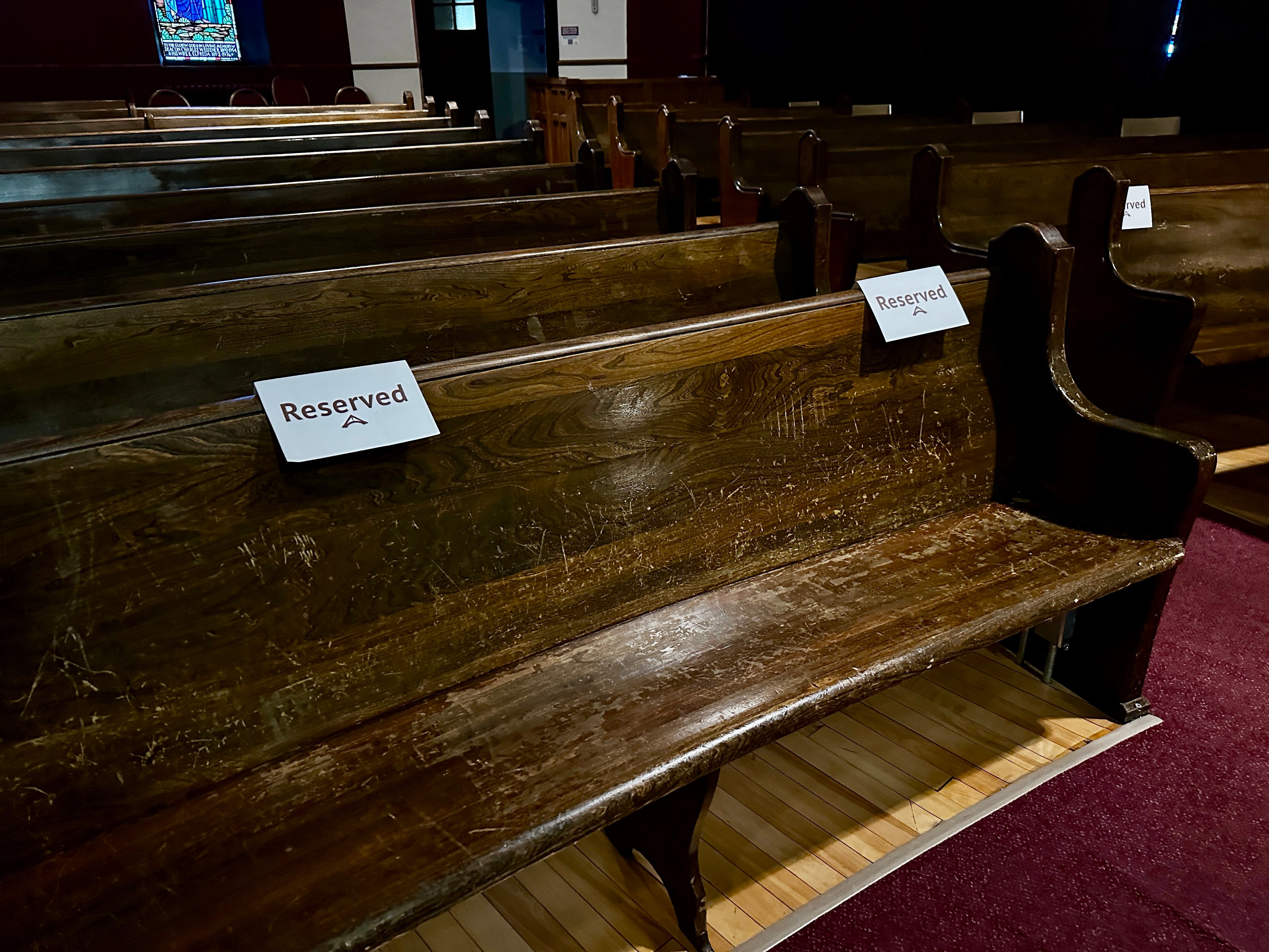 Front row pew seating with reserved signs