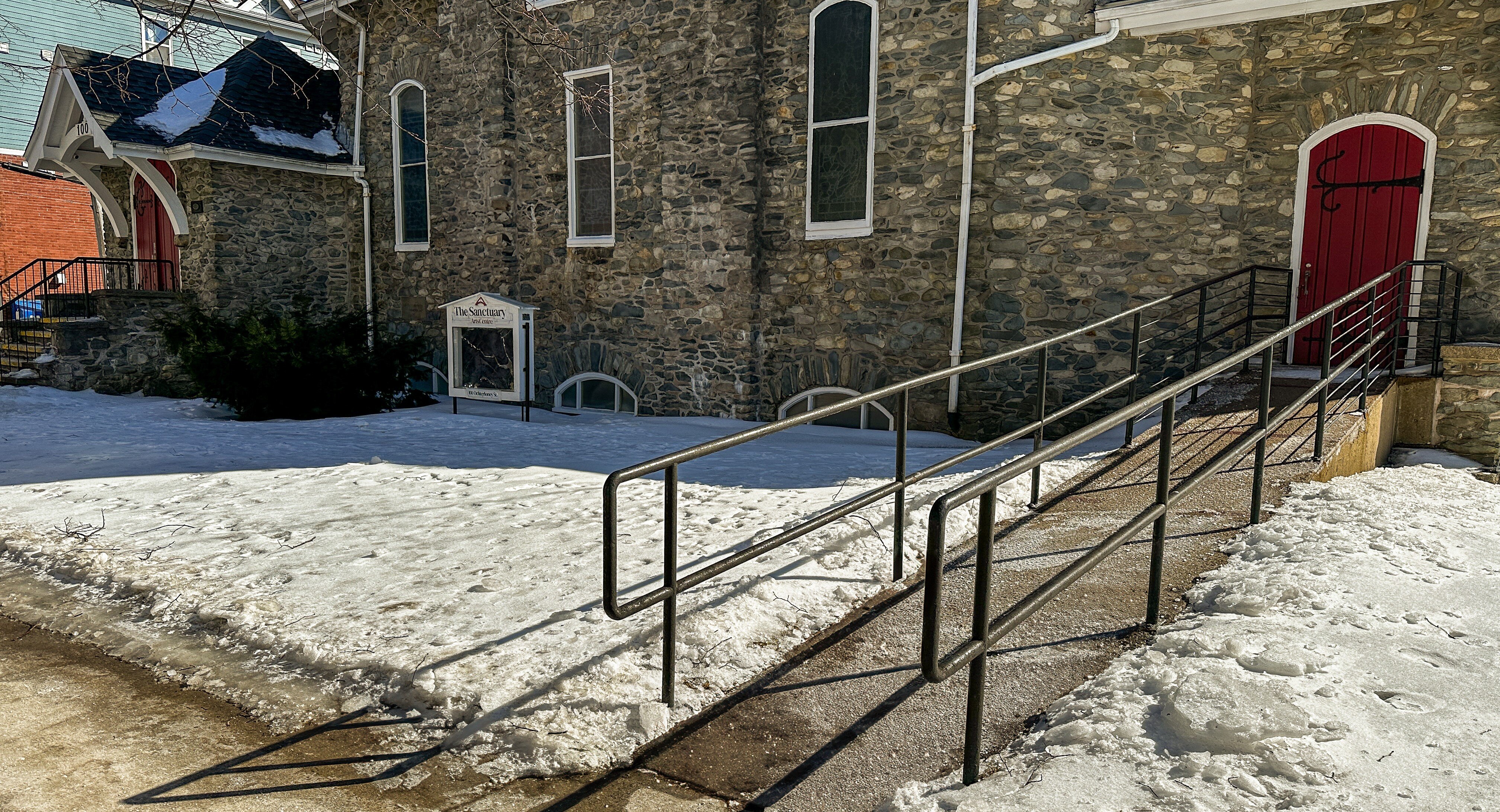 Cleared ramp on a snowy day, leading from Ochterloney Street to the entrance of the Sanctuary Hall